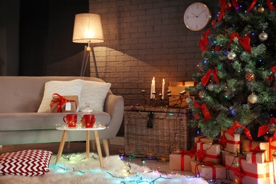 Photo of Stylish room interior with decorated Christmas tree