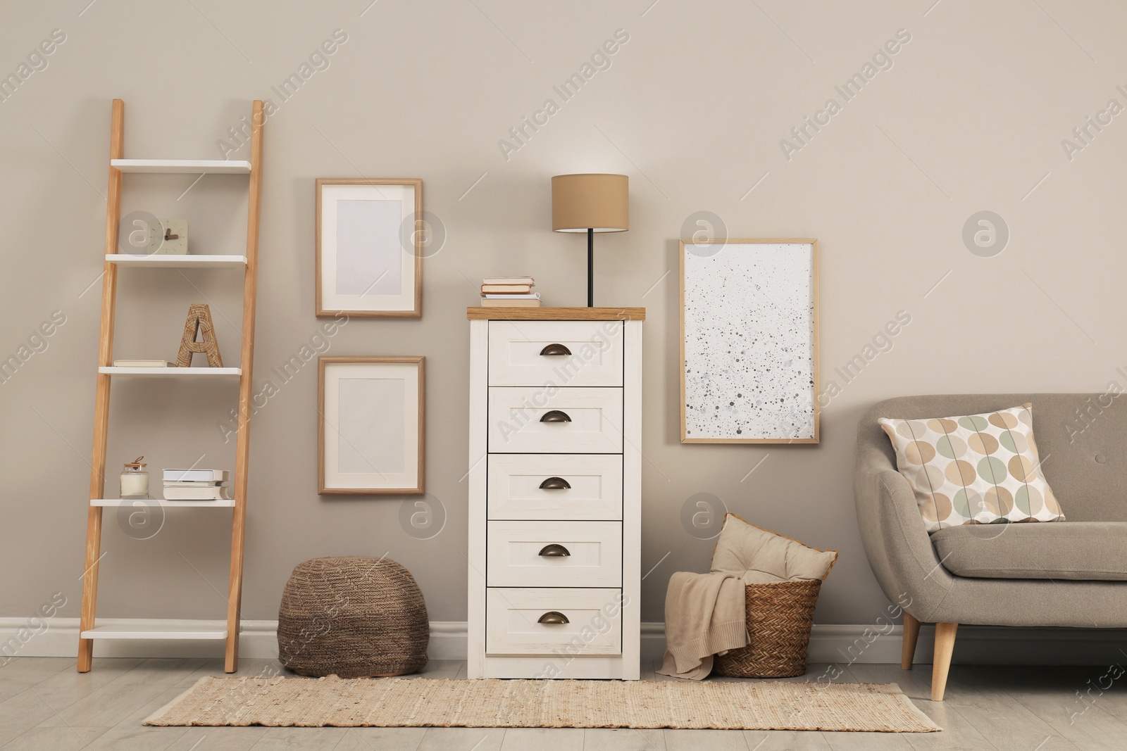 Photo of Modern room interior with chest of drawers near light wall