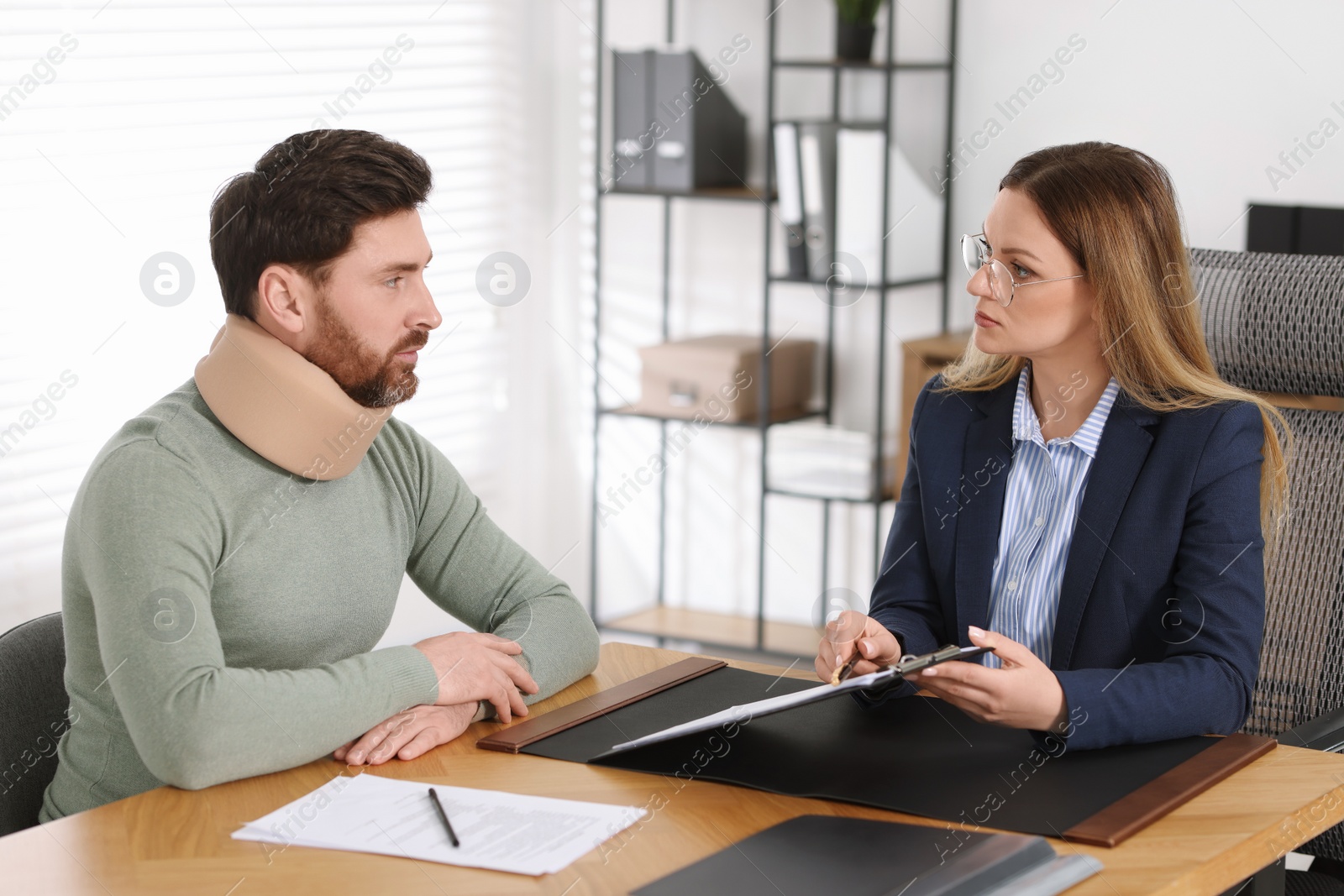 Photo of Injured man having meeting with lawyer in office