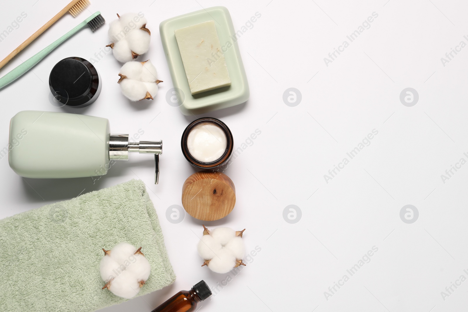 Photo of Bath accessories. Different personal care products and cotton flowers on white background, flat lay with space for text