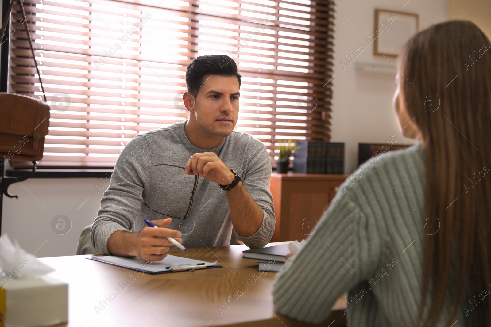 Photo of Professional psychotherapist working with patient in office