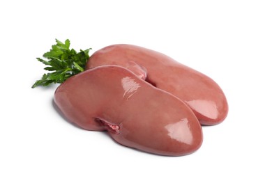 Photo of Fresh raw pork kidneys with parsley on white background