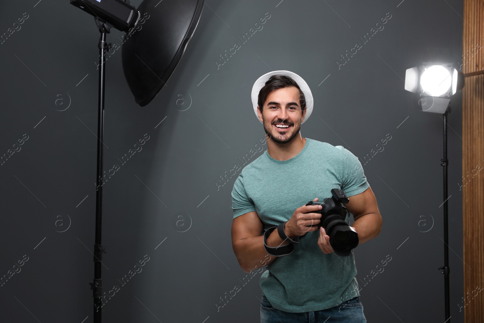 Photo of Professional photographer with modern camera in studio