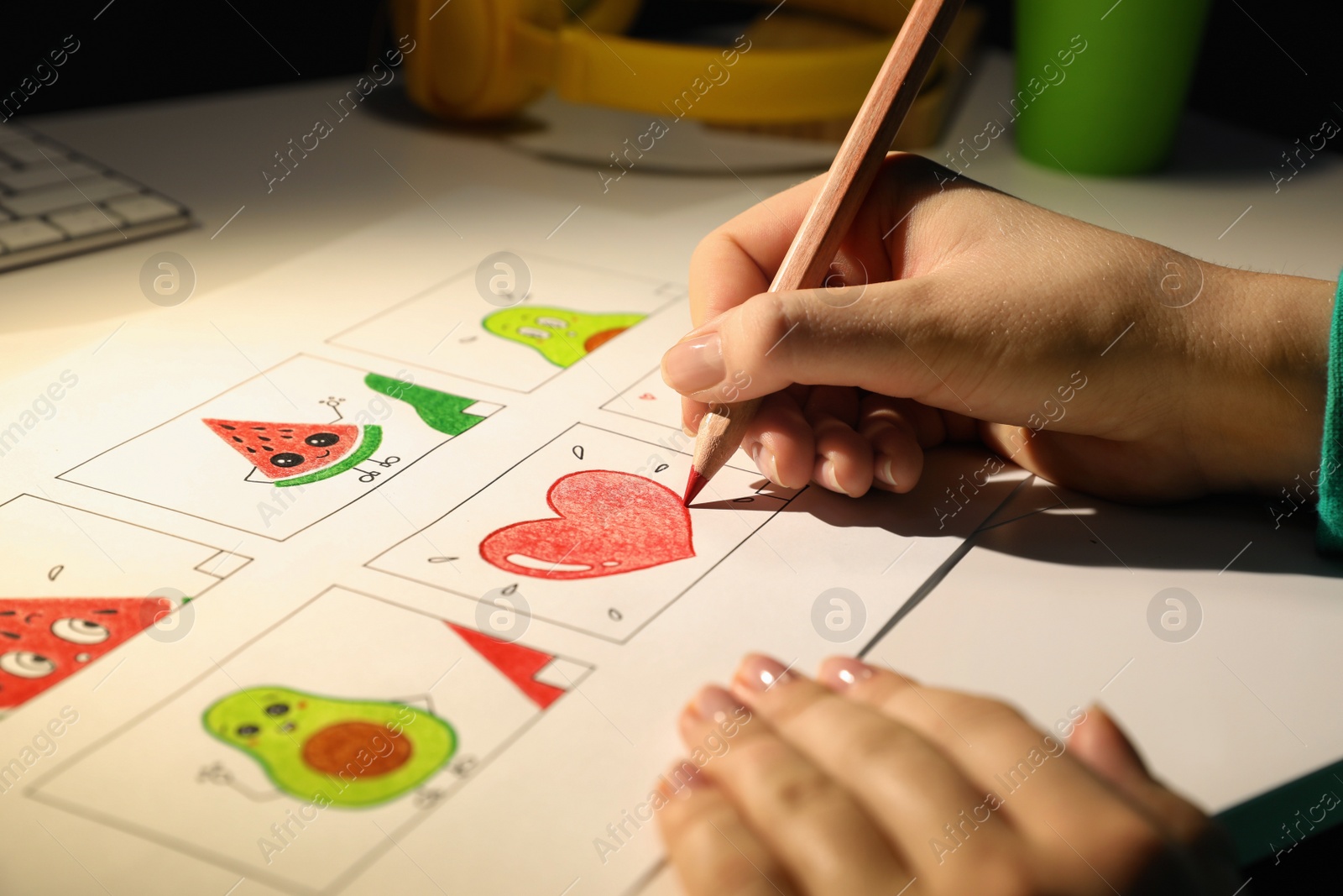 Photo of Woman drawing cartoon sketch at workplace, closeup. Pre-production process