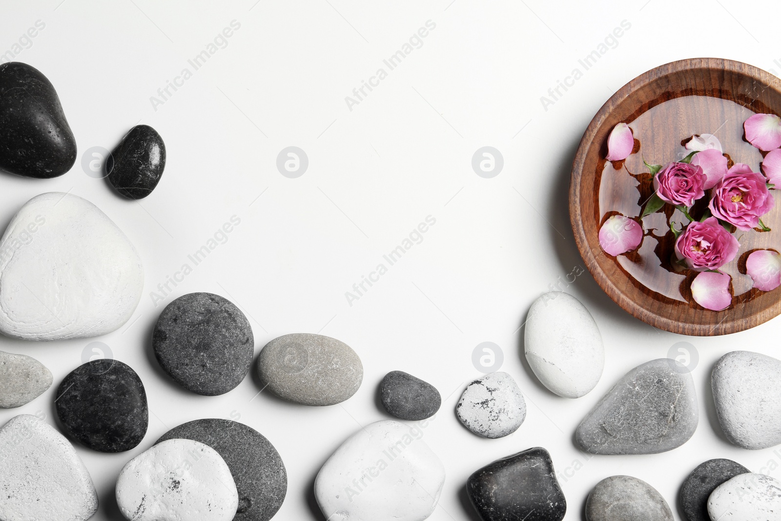 Photo of Flat lay composition with spa stones and space for text on white background