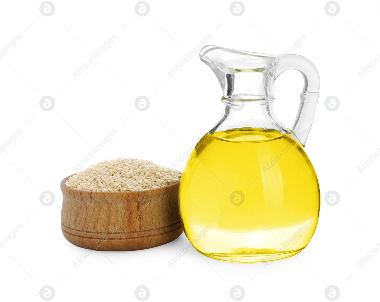 Photo of Glass jug of fresh sesame oil and bowl with seeds isolated on white