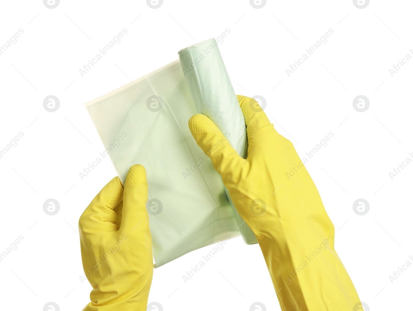 Photo of Person in rubber gloves roll of garbage bags on white background, closeup. Cleaning supplies