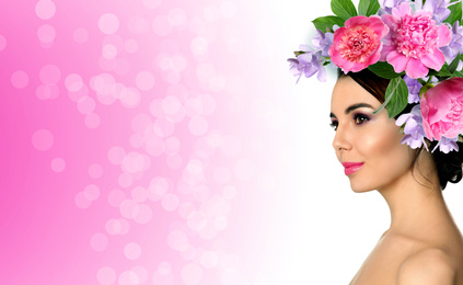 Young woman with beautiful makeup wearing flower wreath on pink background, space for text. Banner design