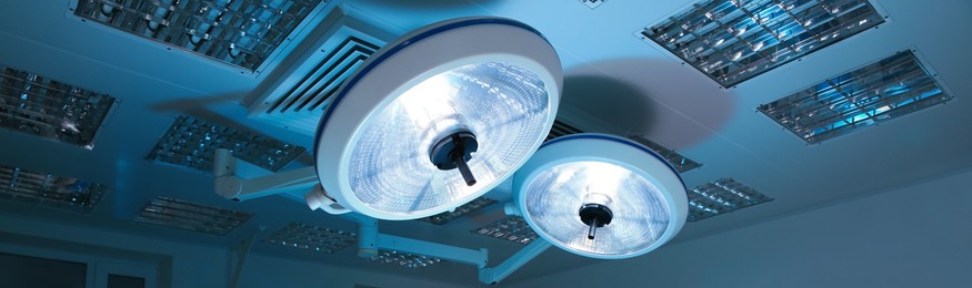Powerful surgical lamps in modern operating room. Banner design