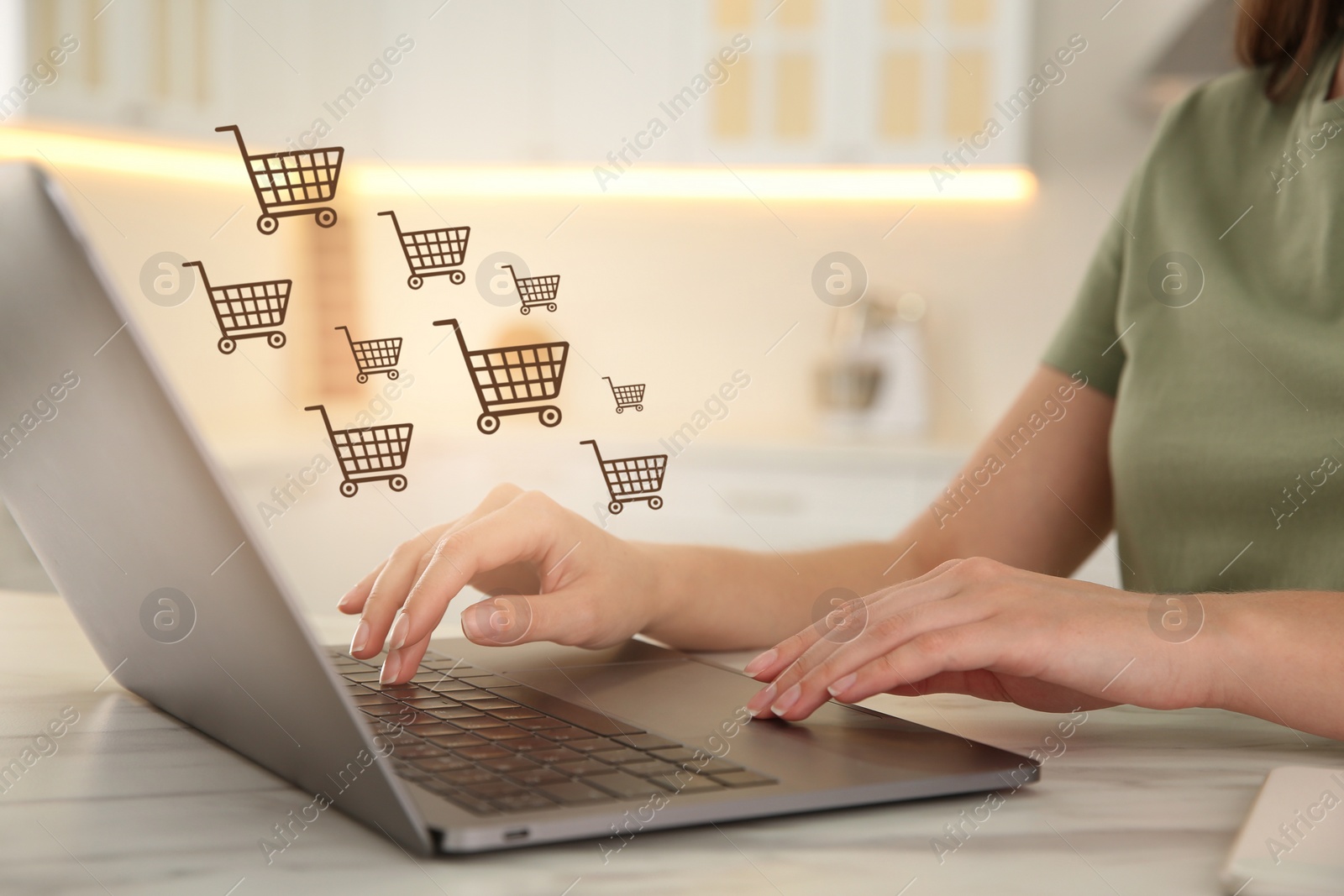 Image of Woman using laptop for online shopping at white marble table, closeup