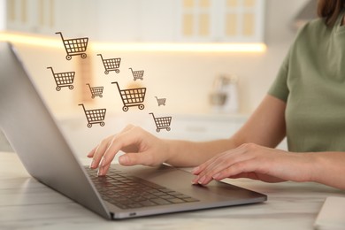 Image of Woman using laptop for online shopping at white marble table, closeup