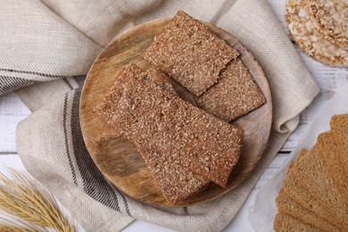 Photo of Rye crispbreads and rusks on table, flat lay