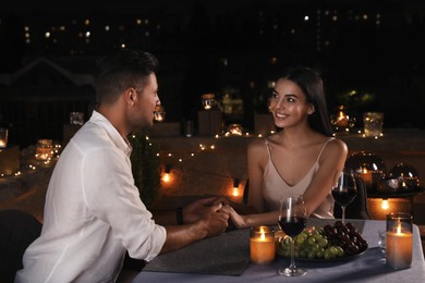 Photo of Romantic couple on cafe terrace at night
