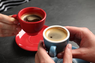 Photo of Women having coffee break at dark table, closeup