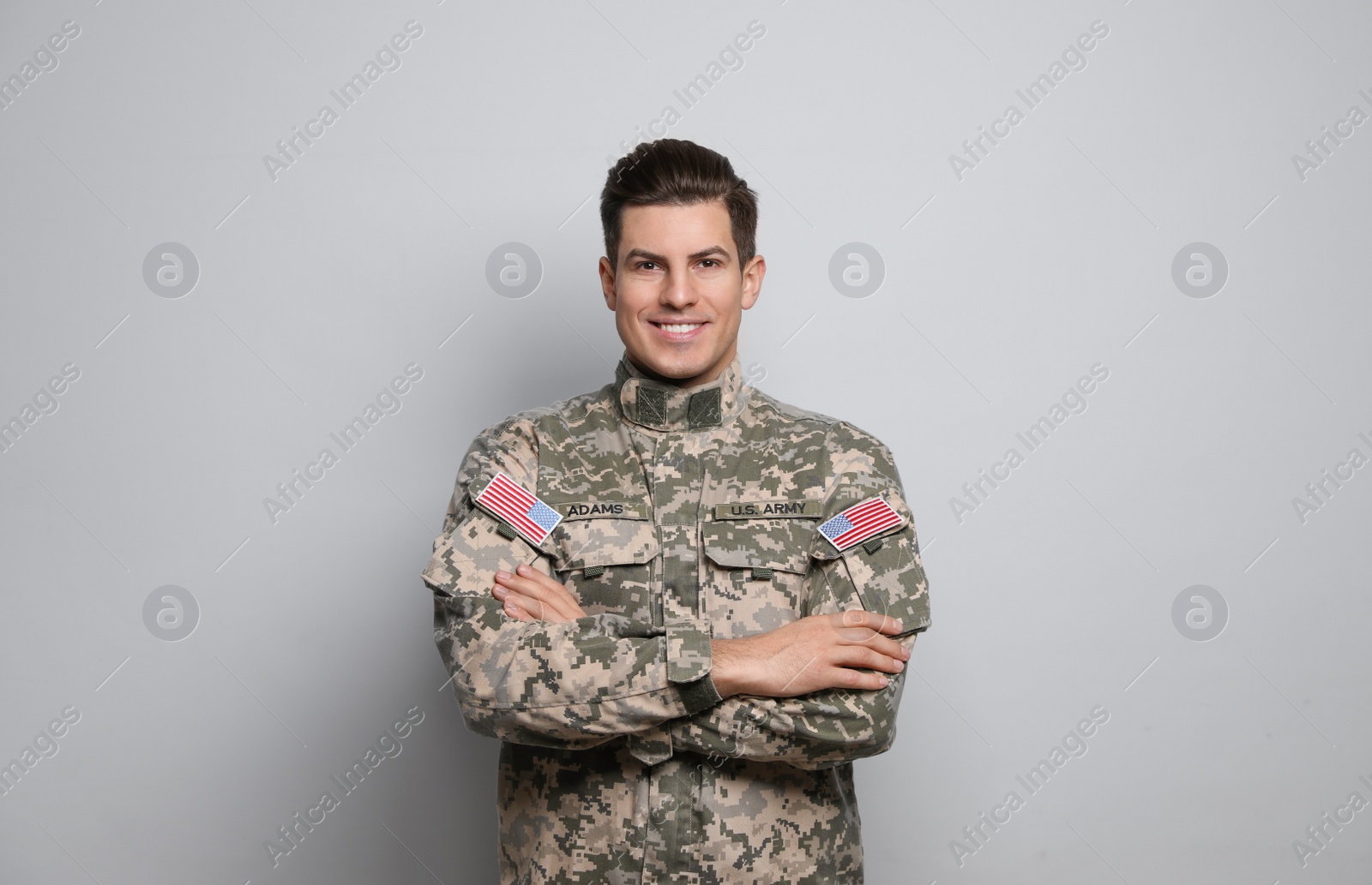 Photo of Portrait of happy cadet on light grey background