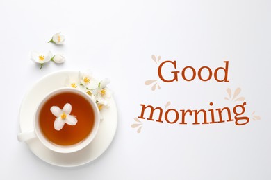 Image of Cup of aromatic jasmine tea and fresh flowers on white background, top view. Good morning