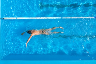 Image of Man training in swimming pool, top view