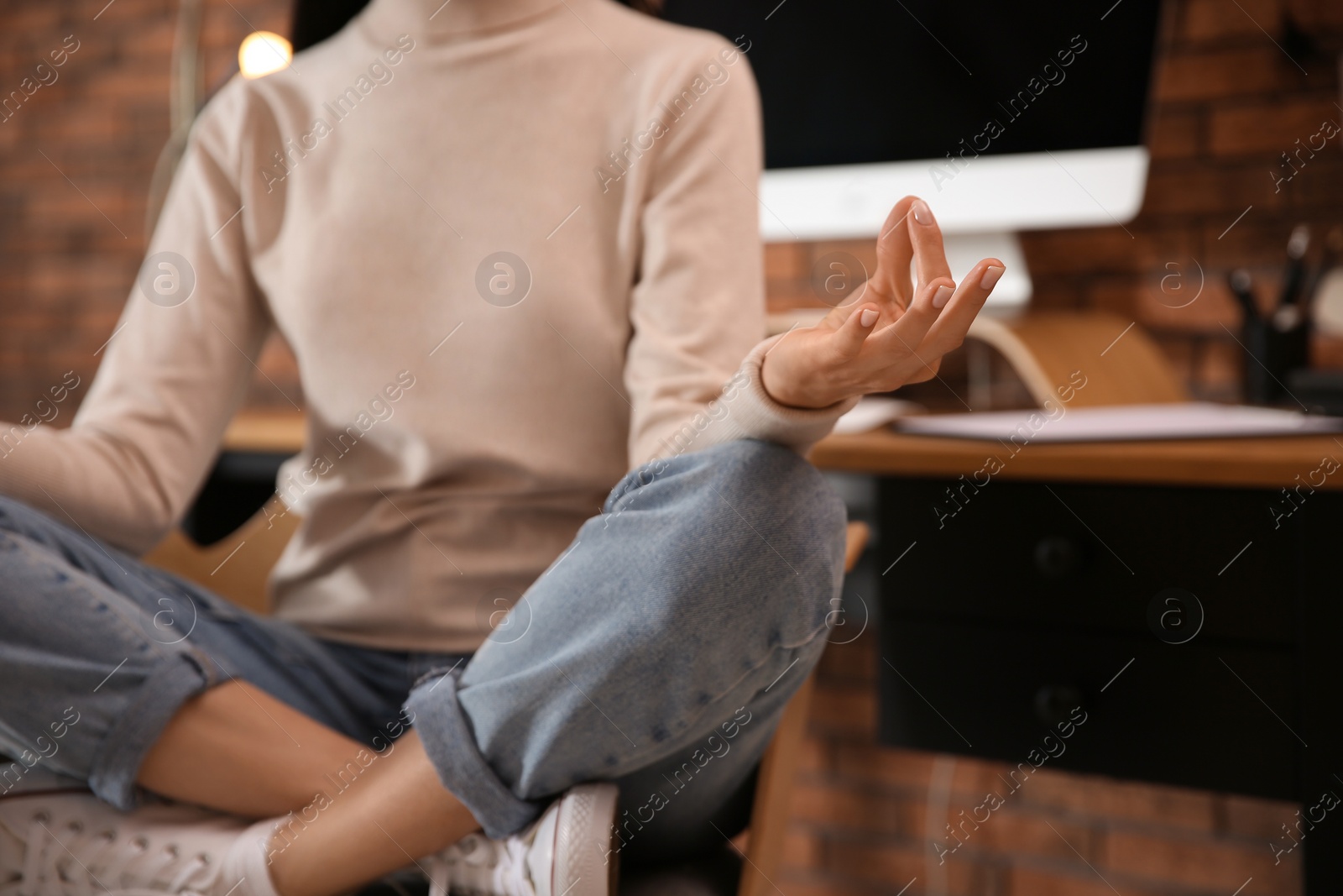 Photo of Woman meditating at workplace in office, closeup