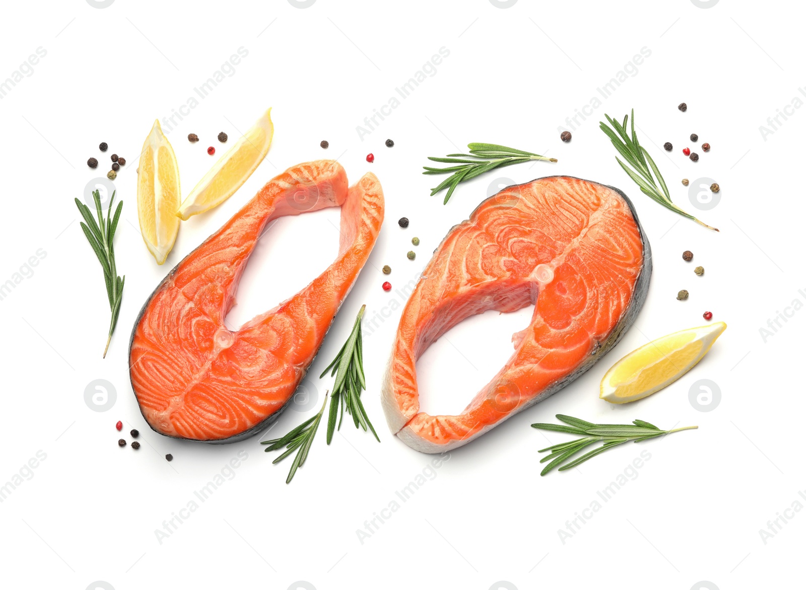 Photo of Fresh raw salmon steaks with rosemary and lemon on white background, top view