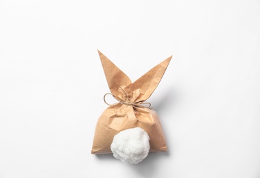 Photo of Creative Easter bunny gift bag on white background, top view