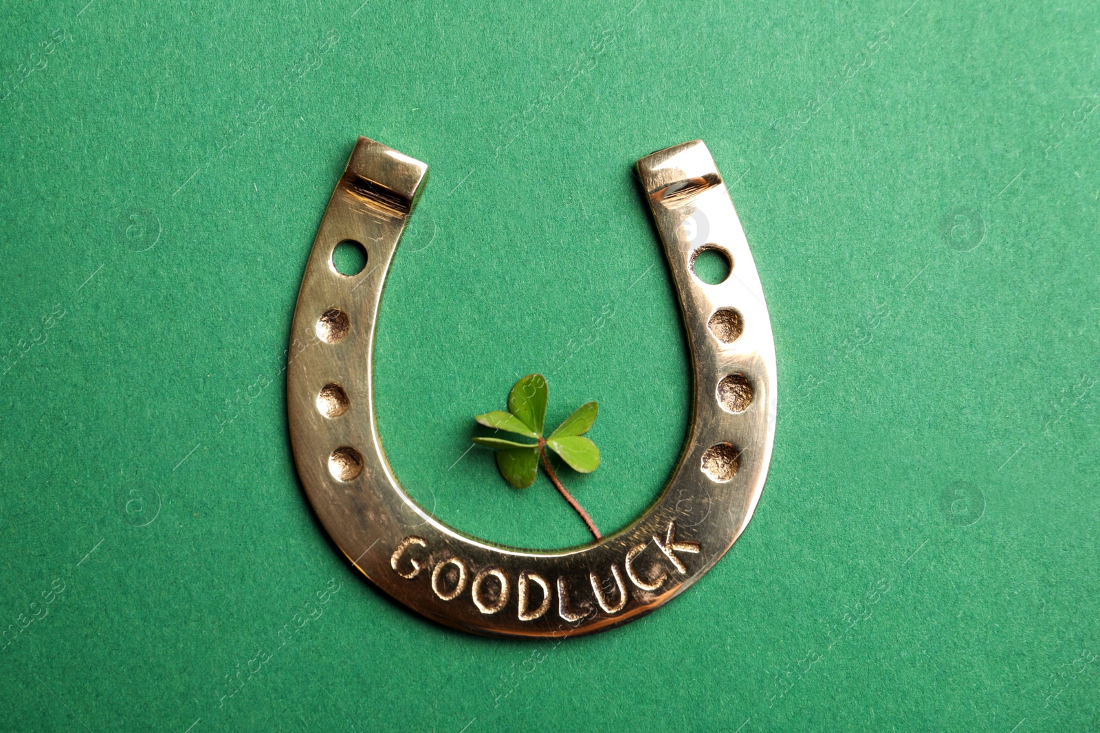 Photo of Flat lay composition with horseshoe on green background. St. Patrick's Day celebration