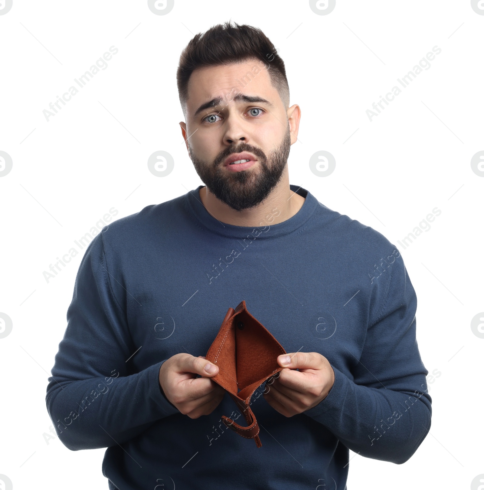 Photo of Upset man showing empty wallet on white background