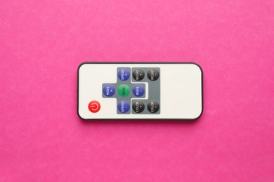 Photo of Remote control on pink background, top view