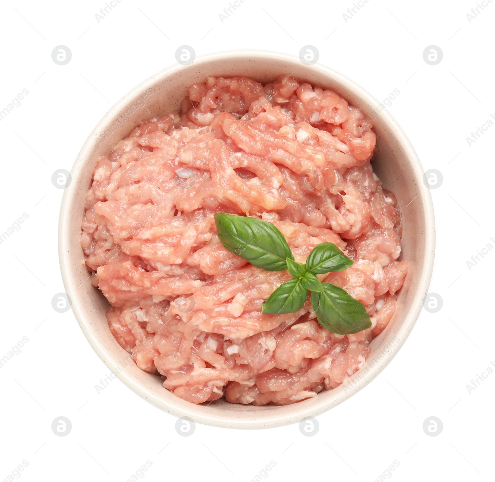 Photo of Raw chicken minced meat with basil in bowl on white background, top view