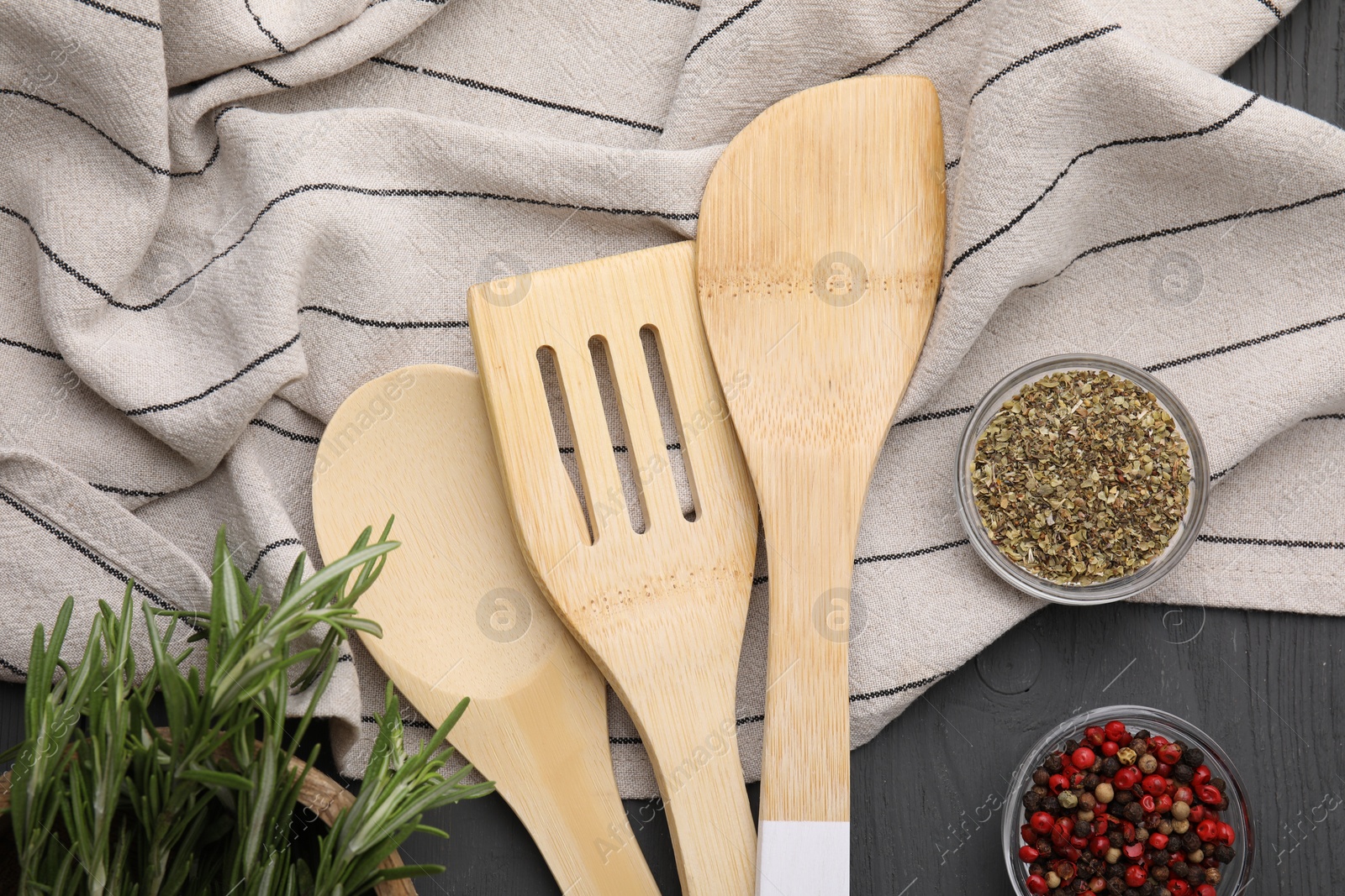 Photo of Set of different kitchen utensils and spices on grey wooden table, flat lay