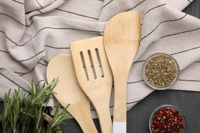 Set of different kitchen utensils and spices on grey wooden table, flat lay