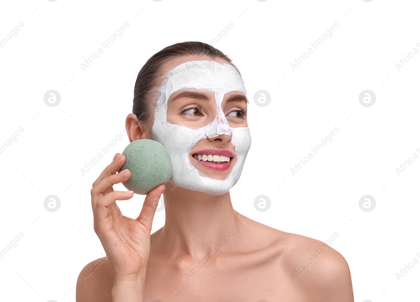 Photo of Happy young woman with face mask and sponge on white background