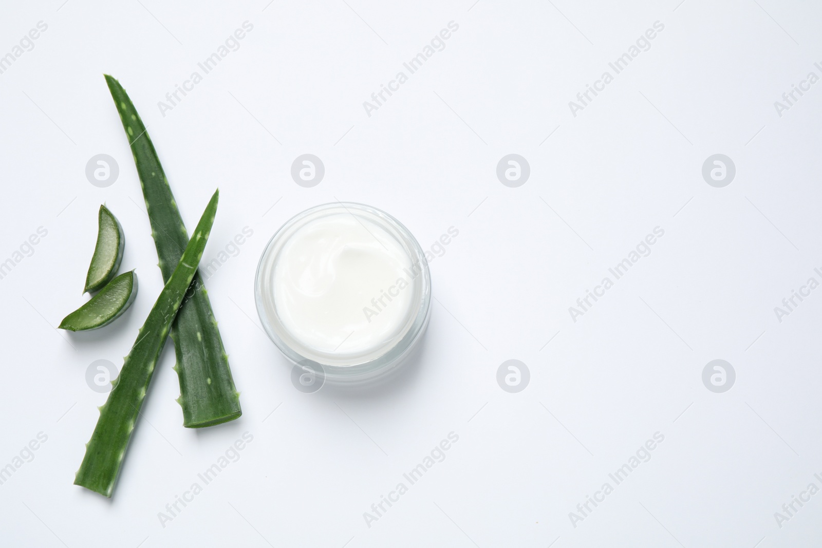 Photo of Open jar of cream and aloe isolated on white, top view. Organic cosmetics