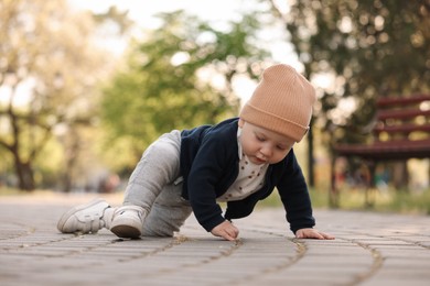 Learning to walk. Little baby crawling in park