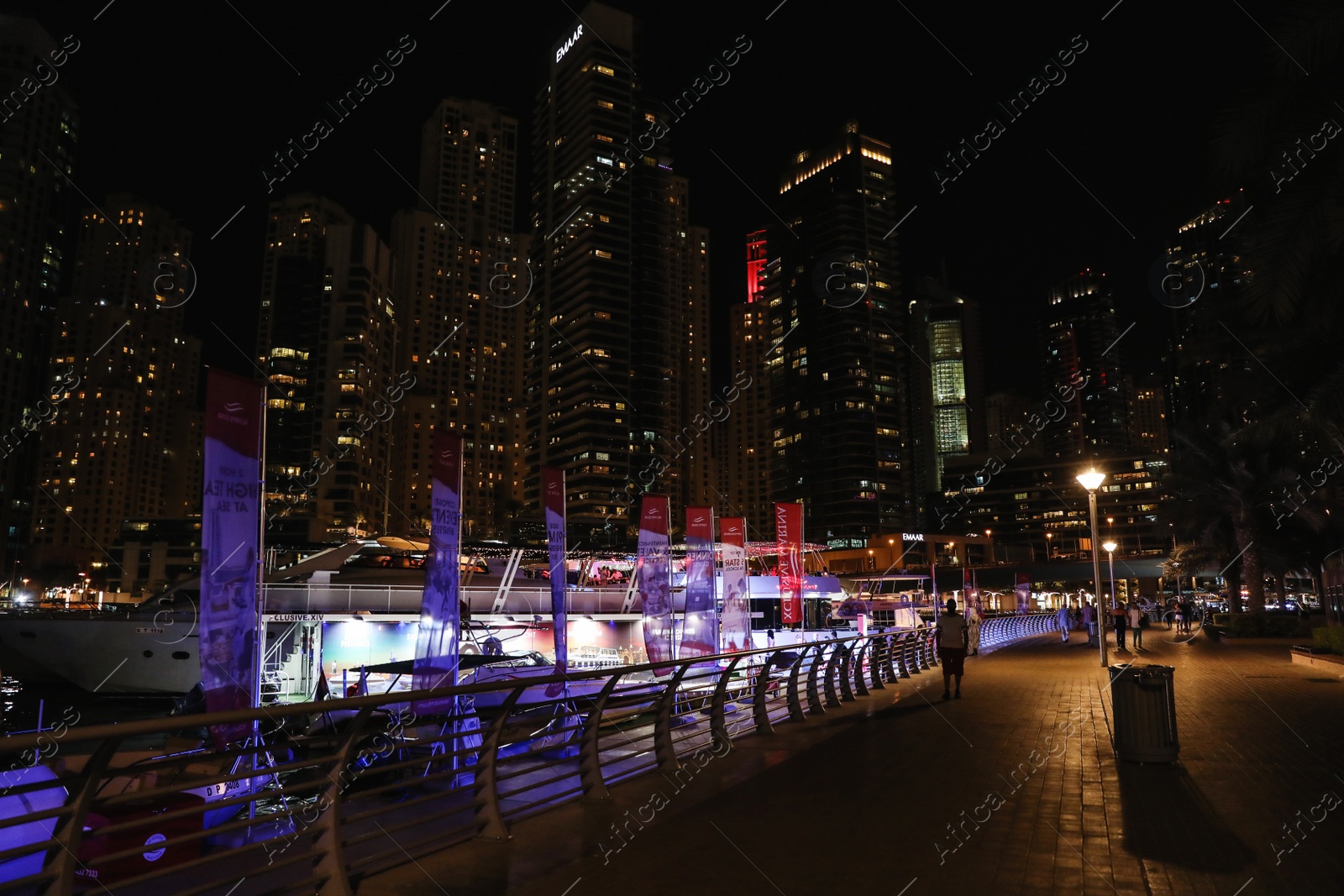 Photo of DUBAI, UNITED ARAB EMIRATES - NOVEMBER 03, 2018: Pier with luxury yachts at night