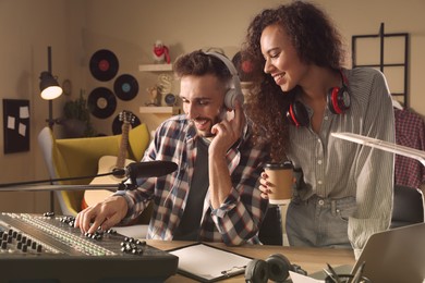 People working in modern radio studio with professional equipment