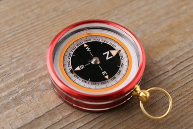 One compass on wooden table. Navigation equipment