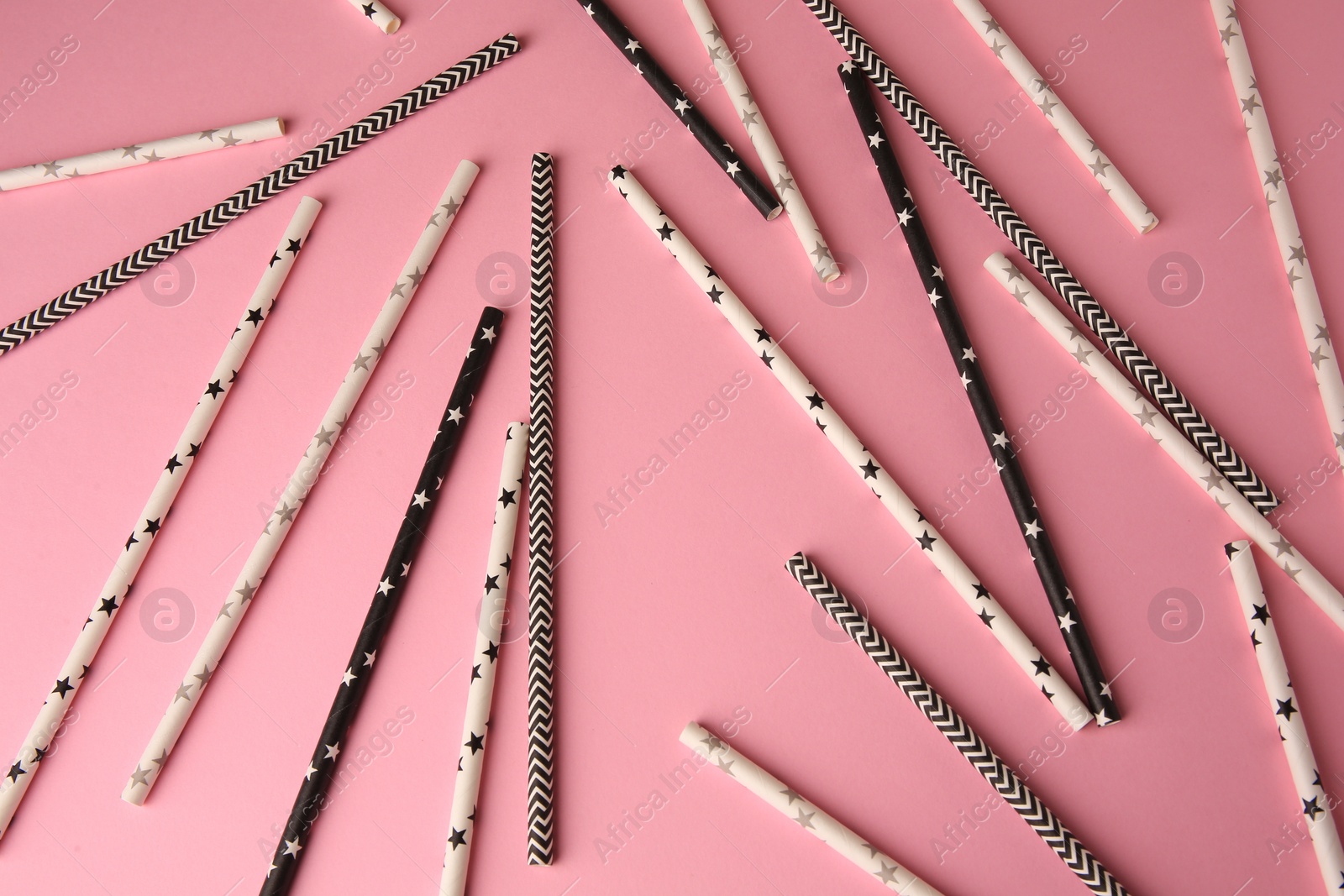 Photo of Many paper drinking straws on pink background, flat lay