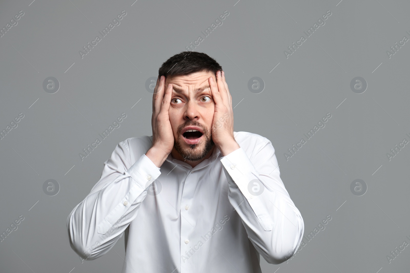 Photo of Portrait of man feeling fear on grey background