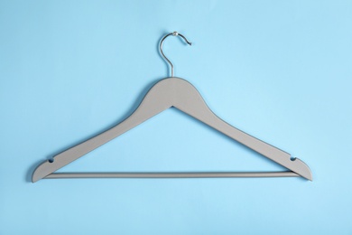 Photo of Empty clothes hanger on color background. Wardrobe accessory