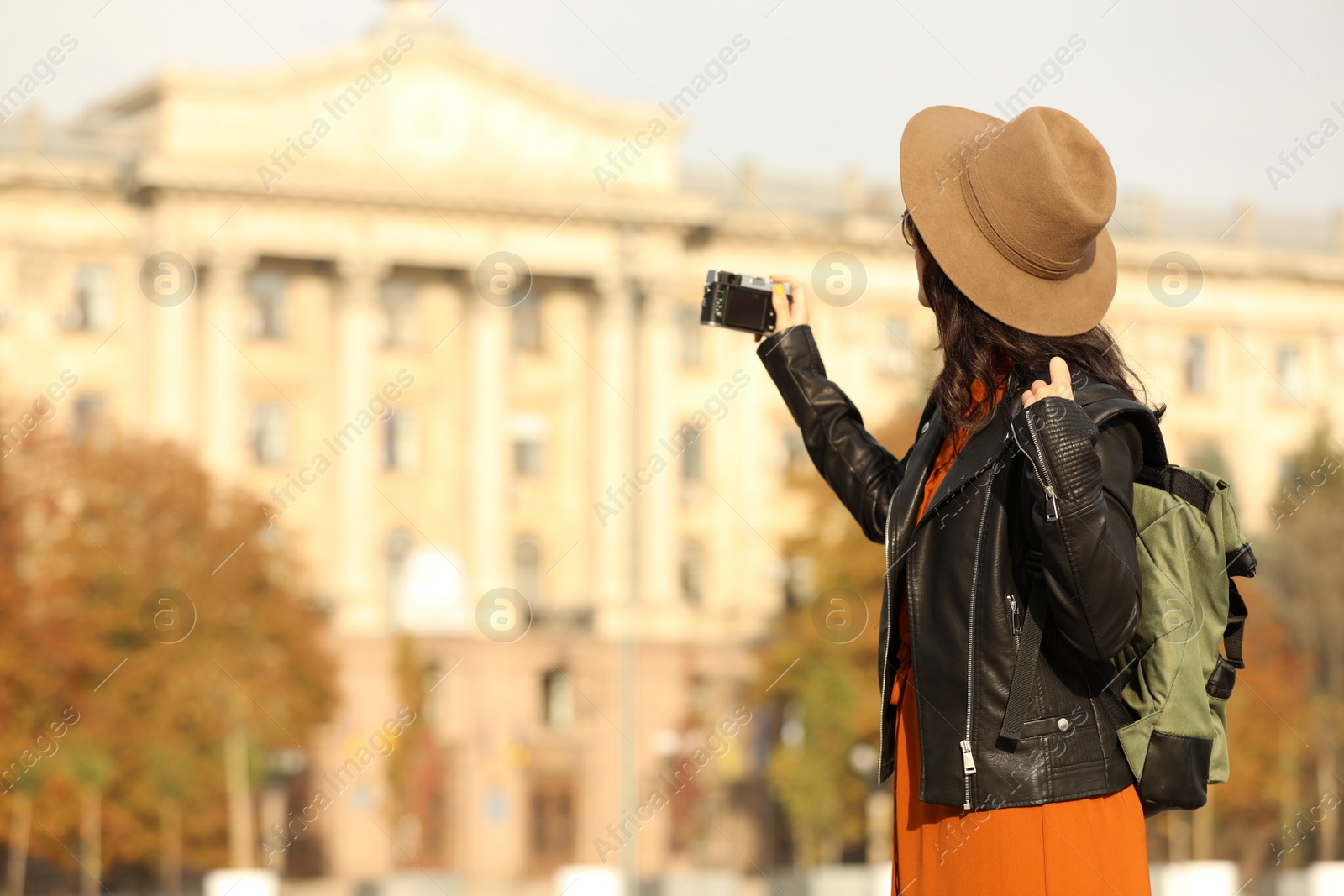 Photo of Traveler with photo camera on city street