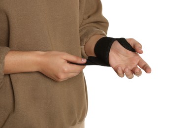 Photo of Woman wrapping hand in medical bandage on white background, closeup