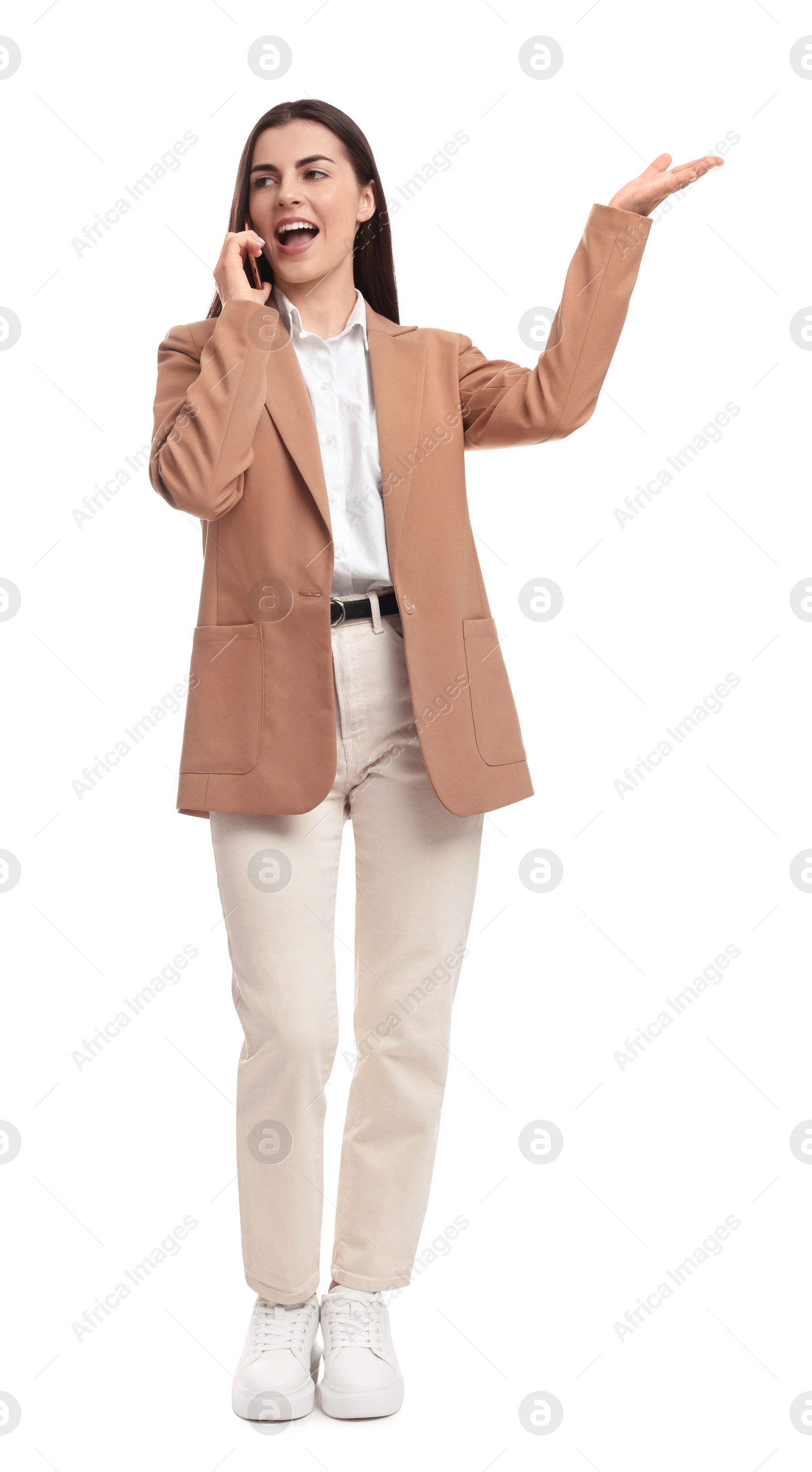 Photo of Beautiful emotional businesswoman talking on smartphone against white background