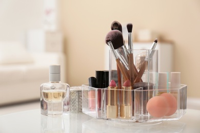 Organizer with cosmetic products for makeup on table indoors