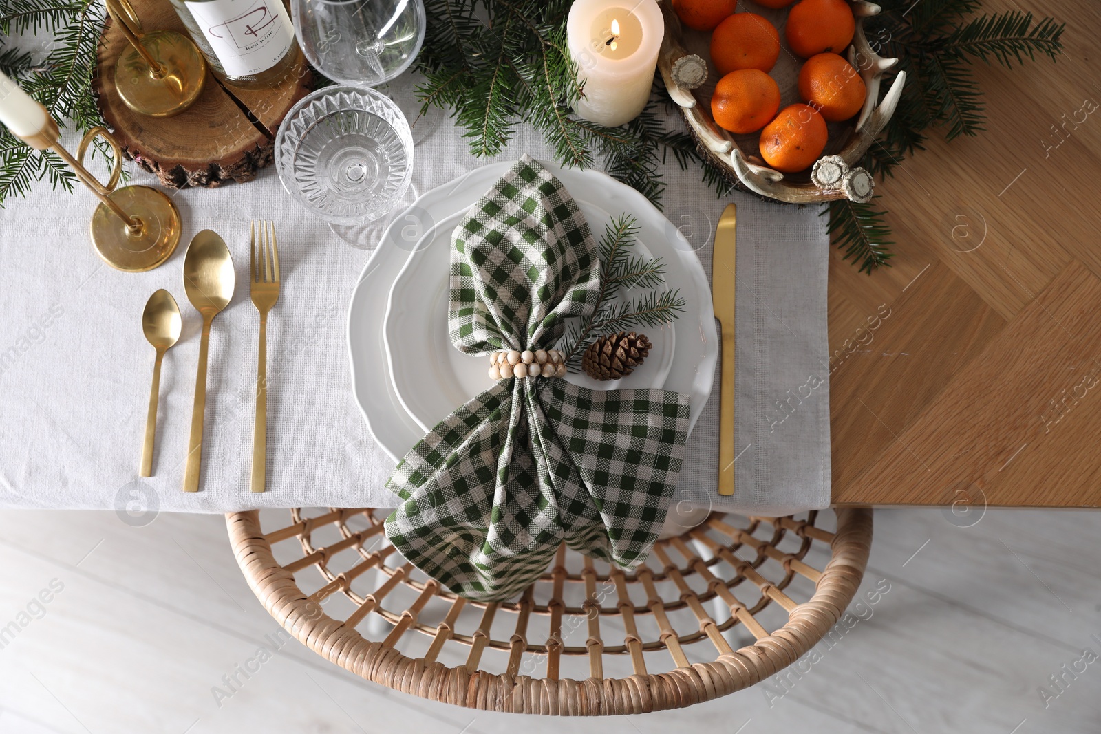 Photo of Christmas table setting with festive decor and dishware, top view