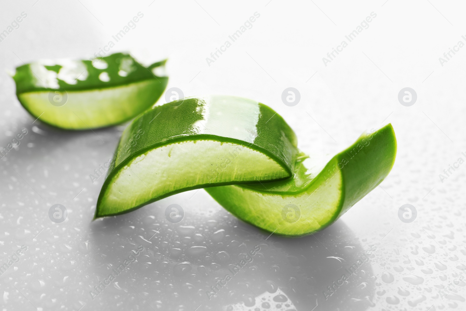 Photo of Slices of aloe vera on white background, closeup