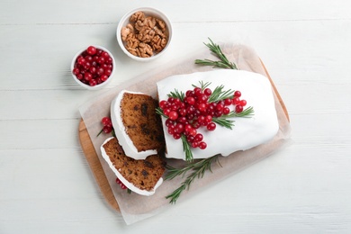 Photo of Traditional Christmas cake and ingredients on white wooden table, flat lay. Classic recipe