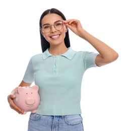 Happy young woman with piggy bank on white background