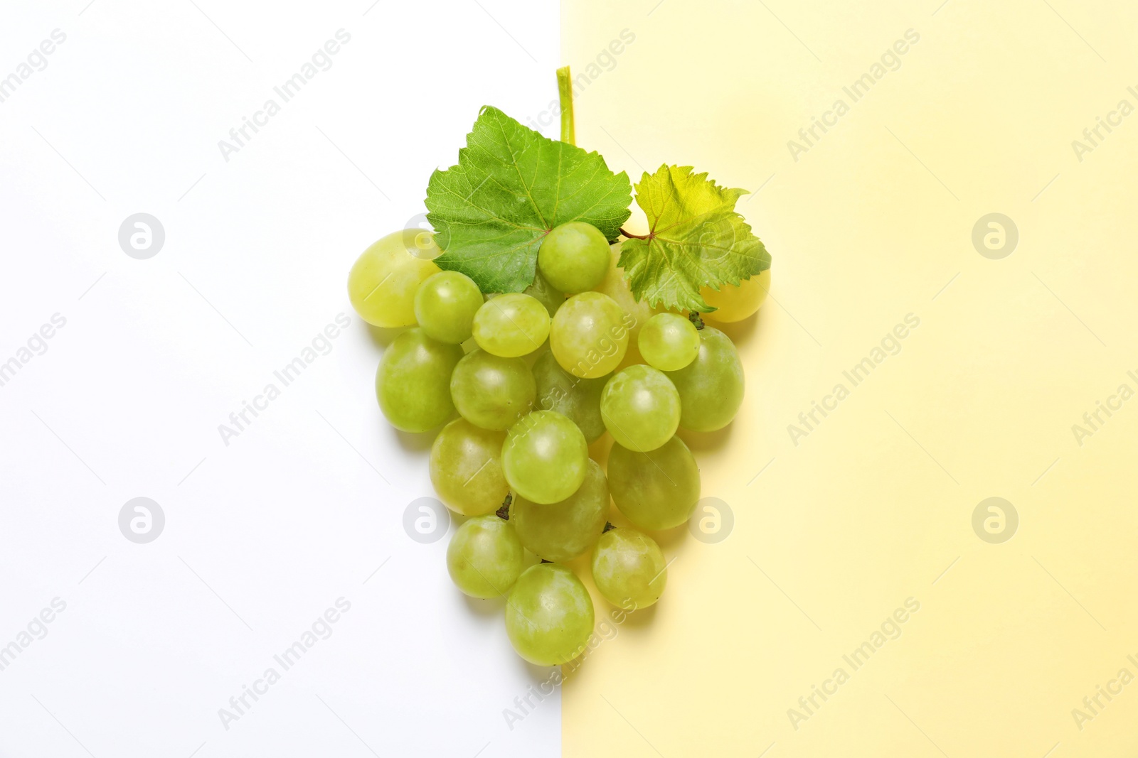 Photo of Fresh ripe juicy grapes on color background, top view