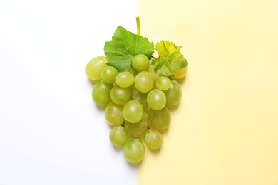 Fresh ripe juicy grapes on color background, top view