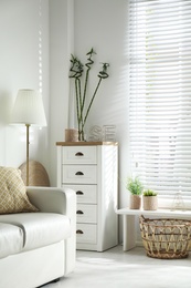 Photo of Beautiful tropical plants with green leaves in stylish living room interior